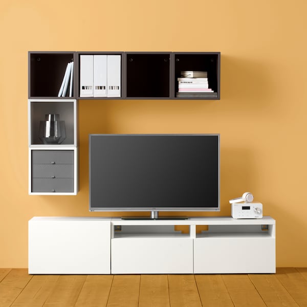 A BESTÅ/EKET cabinet combination against a light yellow wall, with a TV on the TV bench.