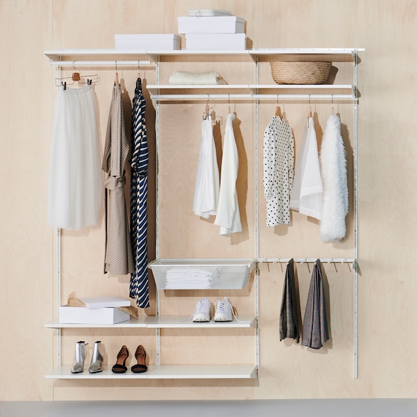 A BOAXEL wardrobe combination with shelves, clothes rails and a mesh basket holding clothes, shoes, boxes and a basket.