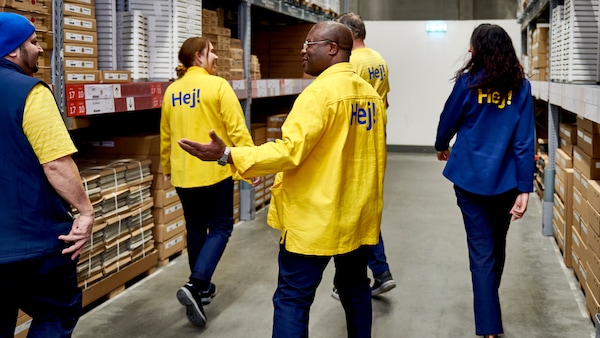 A mixed group of IKEA store co-workers walking through the self service area.