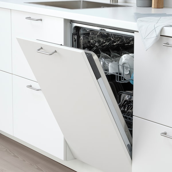 Integrated IKEA dishwasher in white modern kitchen that is open, showing clean plates and cups.