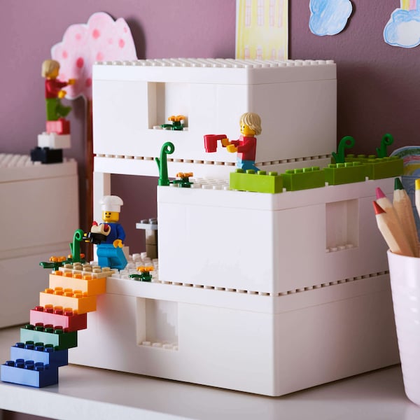 Lego house on table in kid's room.