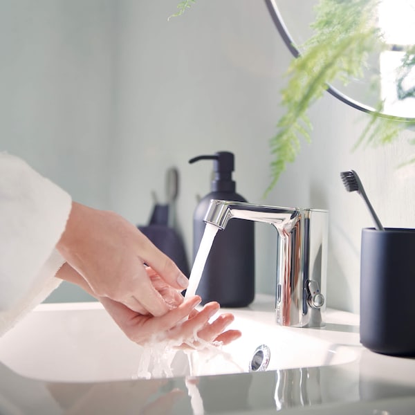 Person washing hands in a sink