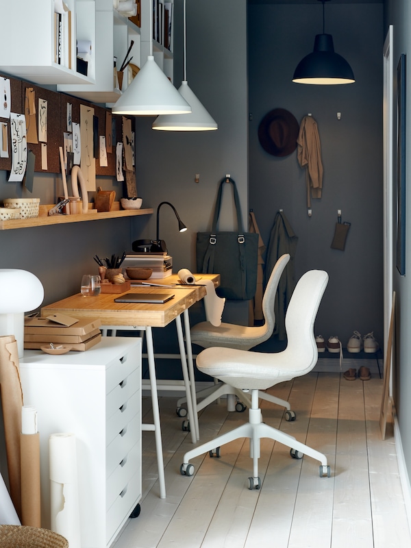 A hallway with two LILLÅSEN desks, two beige/white LÅNGFJÄLL office chairs, three pendants and different storage solutions.