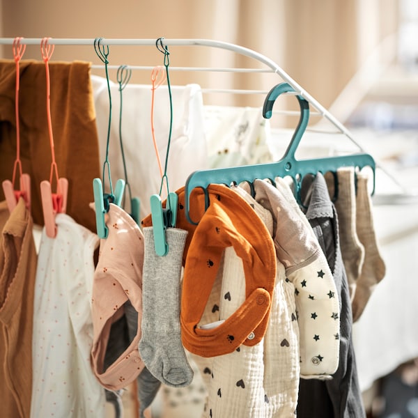 Hang-drying garments on SLIBB hanging pegs and a SLIBB hanger, arranged on a white MULIG drying rack.