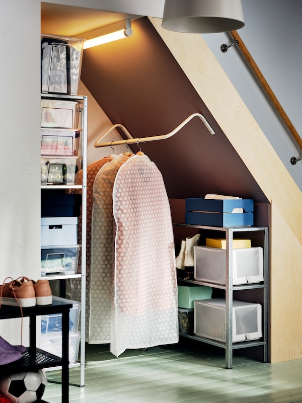 A nook in a hallway with a hanging rail and HYLLIS storage units for seasonal coats and footwear.
