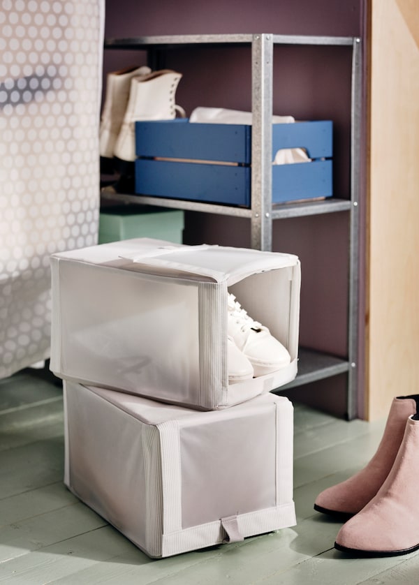 Two white HEMMAFIXARE shoe boxes are used for storing seasonal footwear.