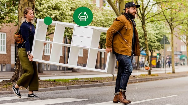 Two people moving IKEA furniture 