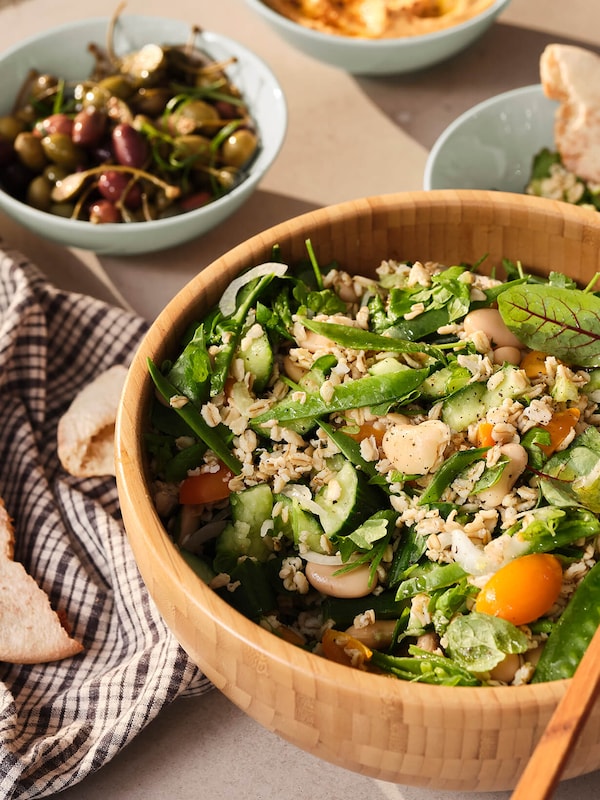 Wood bowl filled with salad bowl on table